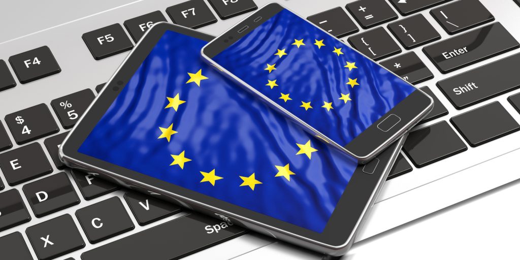 Image of keyboard, tablet and mobile phone with European flag